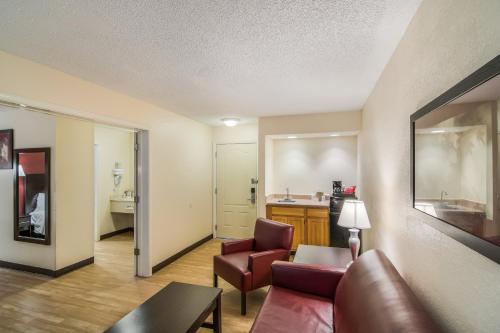 a living room with a couch and a table at Red Roof Inn & Suites Pensacola East - Milton in Milton