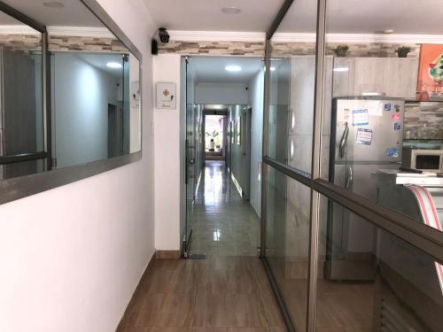 a hallway with glass doors and a hallway leading into a room at Casa Vera Cartagena in Cartagena de Indias