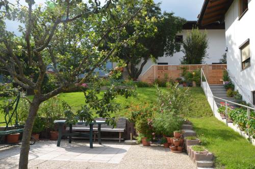a garden with a bench and a table and some plants at Ferienwohnung Garber in Uderns