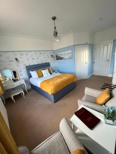 a bedroom with a bed and a living room at Between the Bays exclusively for Adults in Llandudno