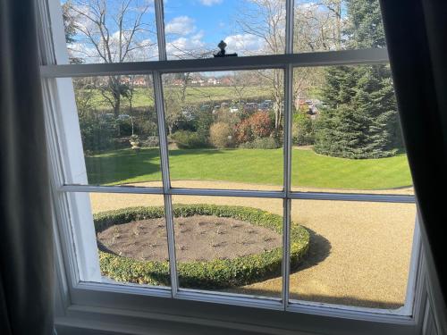 a window with a view of a garden at Park Farm Hotel in Norwich