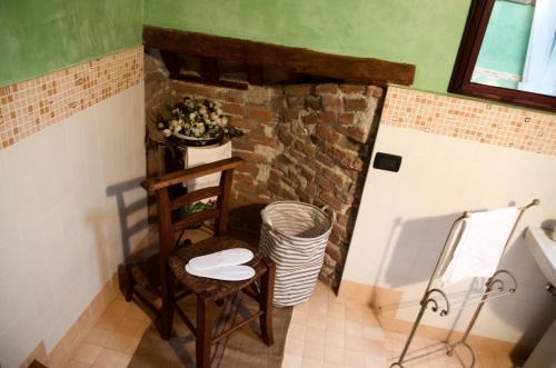 a room with a table and a chair and a brick wall at B&B FETONTE in Crespino