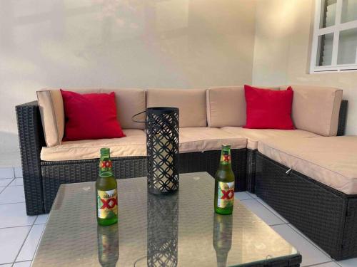 two bottles on a table in a living room with a couch at Otay Studio great patio near Otay Crossing & Airport in Tijuana
