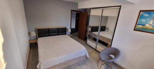 ママイア・ノルドにあるApartment Sun Mamaia Nordの小さなベッドルーム(ベッド1台、鏡付)