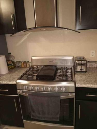 a kitchen with a stove top oven in a kitchen at Otay Studio great patio near Otay Crossing & Airport in Tijuana