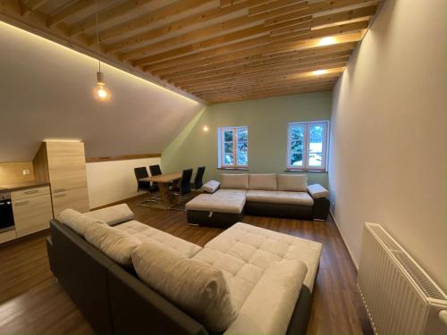 a living room with a couch and a table at Pferdegut Schloss Treffen Apartments in Görtschach