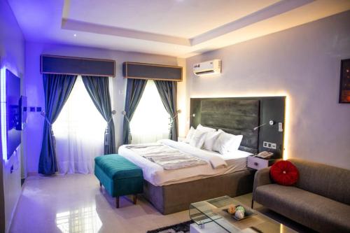a hotel room with a bed and a couch at Zucchini Hotel and apartments in Umueme