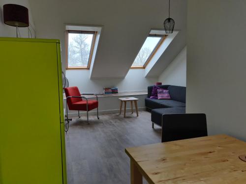 a living room with a couch and a table at LOGEMENT DE SCHOOL Middelburg in Middelburg