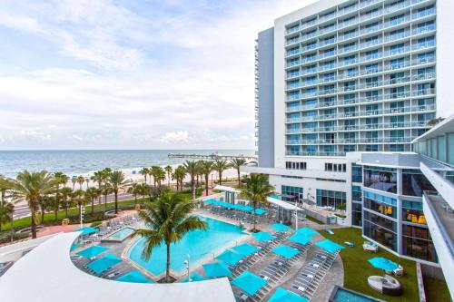 an aerial view of a hotel with a pool and the ocean at Wyndham Grand Clearwater Beach in Clearwater Beach