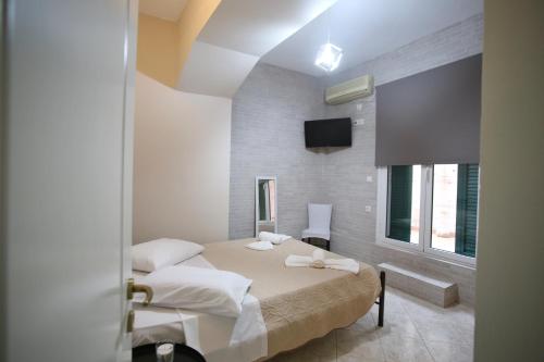 a bedroom with two beds and a flat screen tv at Anna's House in Vlikhón