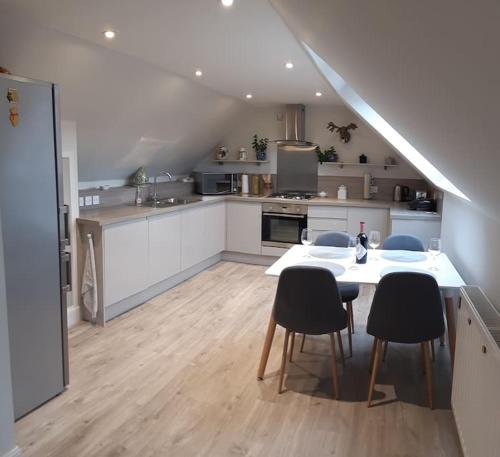 a kitchen with a table and chairs in a room at Pinewood Cottage - Quiet and peaceful Blairgowrie in Blairgowrie