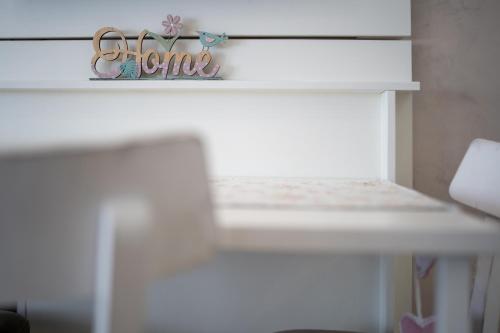 a white shelf with a sign that says aunt at Apartman Tajena in Zlatibor