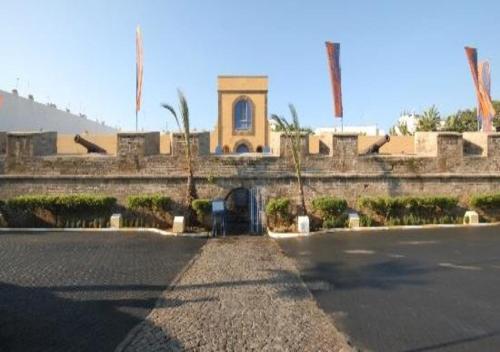a building with a clock tower in front of a street at luxury apartment of 80m2 opposite HASSAN 2 MOSQU and SEA , near downtwn from family , INTERDIT COUPLES ARAABIC NON MARIÈ, FORBIDDEN UNMARRIED ARAABIC COUPLES , basement car park FREE in Casablanca