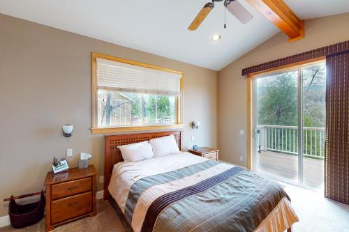 a bedroom with a bed and a large window at Murray Lake Retreat in Bass Lake