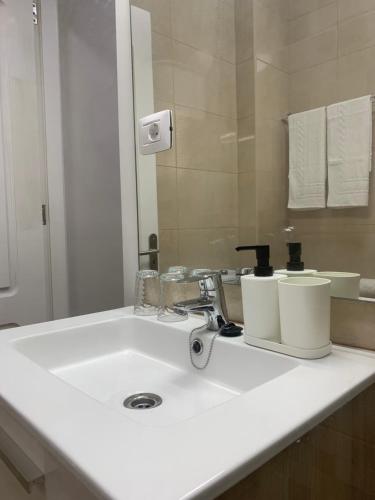 a bathroom with a white sink and a mirror at Casa Pablo II Aptº Tranquilo, a cinco minutos del Puerto de la Cruz in Los Realejos