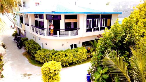 
a large house with a balcony overlooking the ocean at Infinity Dhiffushi in Dhiffushi
