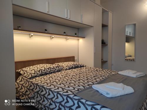 a bedroom with a bed with two towels on it at BLU apartment in Civitanova Marche