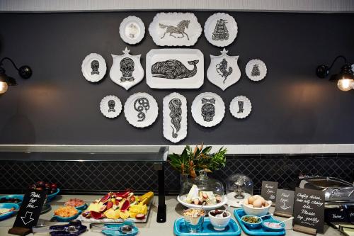 a table with plates and food on a wall at View Brisbane in Brisbane
