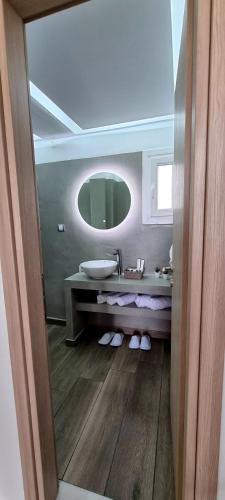 a bathroom with a sink and a mirror at Ether in Perivolos