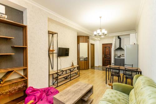 a living room with a couch and a table at Apartment 16 in Tbilisi City