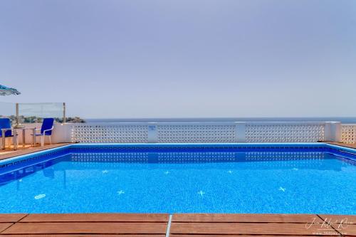a large swimming pool with a view of the ocean at Sobre de Granadella Haus 5 in Jávea