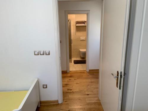 a hallway with a toilet and a door to a bathroom at Alex Apartments in Budva