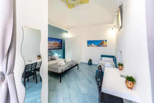 two pictures of a room with a bed and a table at La casa del postino in Procida