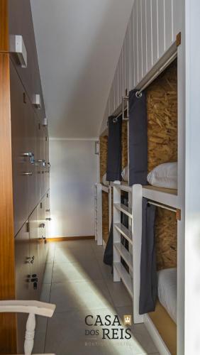 a room with several bunk beds in a room at Casa Dos Reis - Boutique Hostel in Angra do Heroísmo