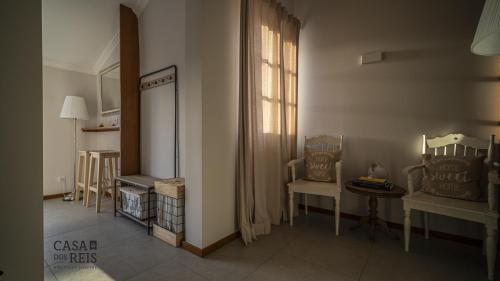 a living room with two chairs and a window at Casa Dos Reis - Boutique Hostel in Angra do Heroísmo