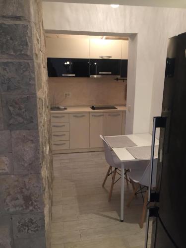 a kitchen with a table and a dining room at Alex Apartments in Budva