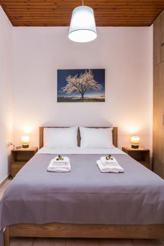 a bedroom with a bed with two towels on it at Chrysa House Kissamos in Kissamos