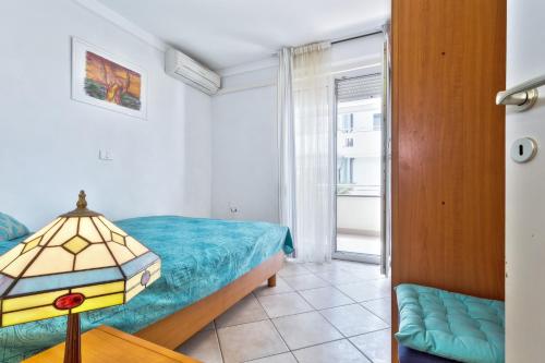 a small bedroom with a bed and a window at InBlue in Savudrija