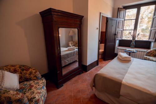 a bedroom with a large bed and a large mirror at Castell Granadella in L'Ampolla