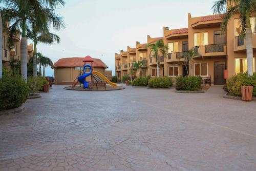 a playground in the middle of a courtyard at a resort at Alahlam Resort Yanbu in Yanbu