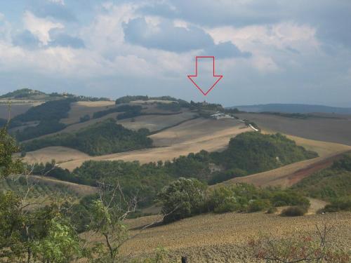 a view of a hill with a red arrow on it at LaCollinaTuscany between San Gimignano and Volterra in Volterra