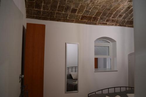 a mirror on the wall of a room at Évora Romana Alojamentos T1 Templo Diana in Évora