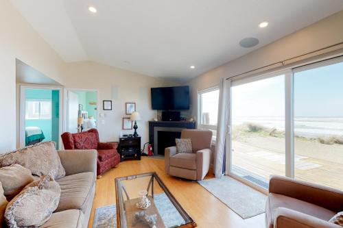 a living room with a view of the ocean at Rockin' Away Beach House in Rockaway Beach