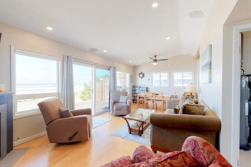 a living room with a couch and chairs and a table at Rockin' Away Beach House in Rockaway Beach