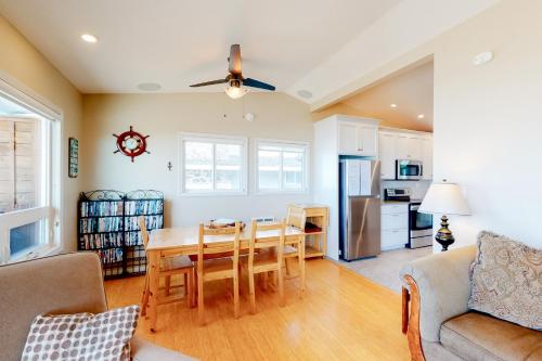 a kitchen and living room with a table and chairs at Rockin' Away Beach House in Rockaway Beach