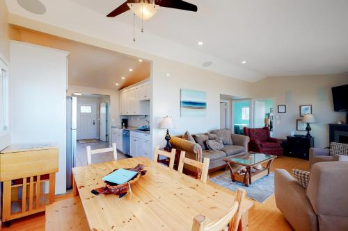a living room with a table and a couch at Rockin' Away Beach House in Rockaway Beach