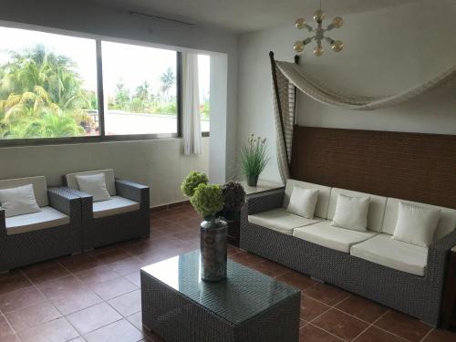 a living room with two couches and a table at Quinta Punta Sam in Cancún