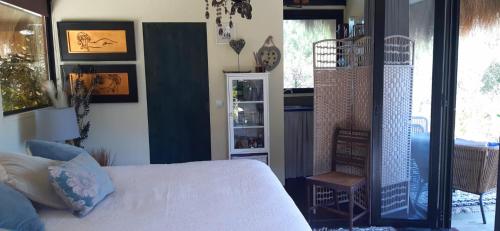 a bedroom with a bed and a clock on the wall at Ying Yang Monte da Lua in Comporta