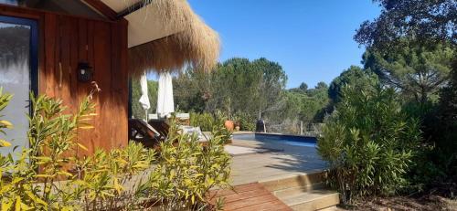 a house with a swimming pool in the yard at Ying Yang Monte da Lua in Comporta