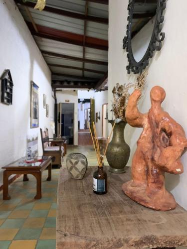 a room with a table with vases and a mirror at Hotel Casa Solárium Posada in Socorro