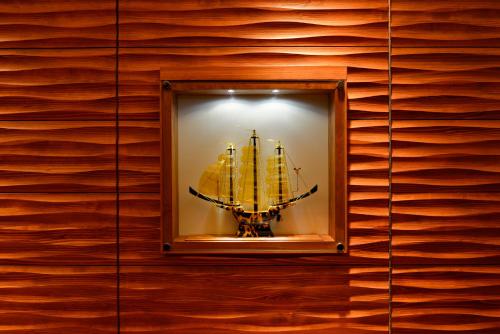 a display case with a ship in a wooden wall at JR Kyushu Hotel Nagasaki in Nagasaki