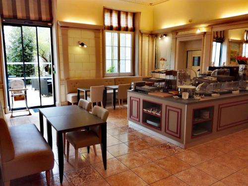a kitchen with a table and chairs in it at Best Western Central Hotel in Tours