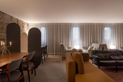 a living room with a couch and a table at Casas Da Lapa, Nature & Spa Hotel in Seia