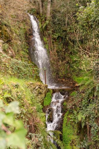 a waterfall on the side of a hill at Casas Da Lapa, Nature & Spa Hotel in Seia