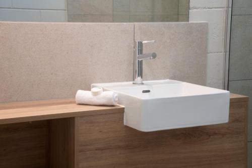 a bathroom with a white sink on a counter at Apartments at Mission Beach in Mission Beach