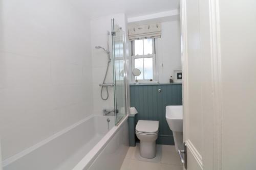 a bathroom with a toilet and a sink at Cool Stone Cottage in Instow